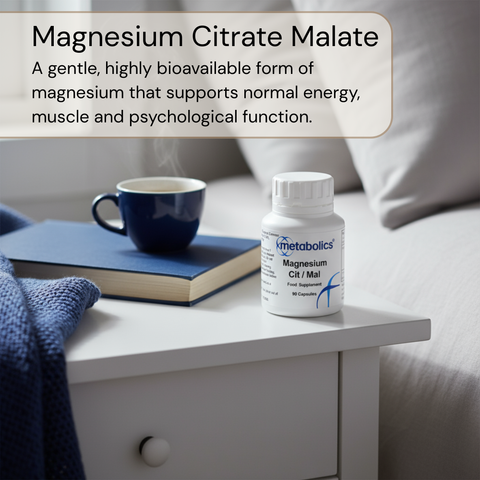 Bottle of Metabolics Magnesium Citrate Malate on a nightstand with a cup and book.