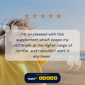 Person holding a supplement with a five-star review on a beach.
