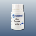 White supplement bottle labeled 'metabolics Zinc Formula' on a gray background